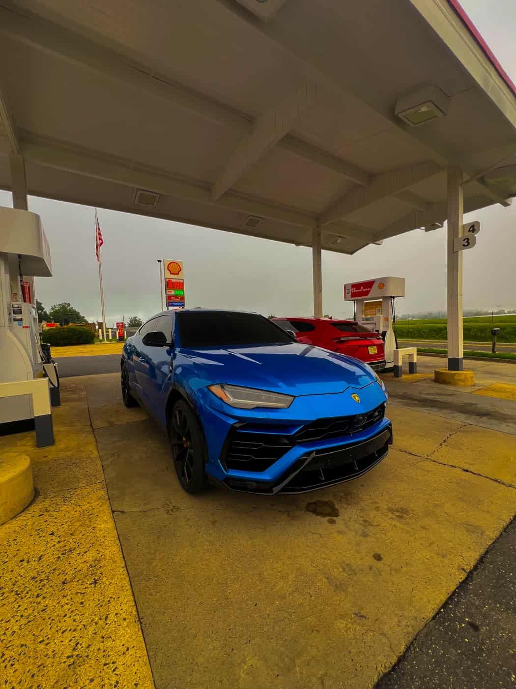 Blue performance SUV shot from a low angle at a service station