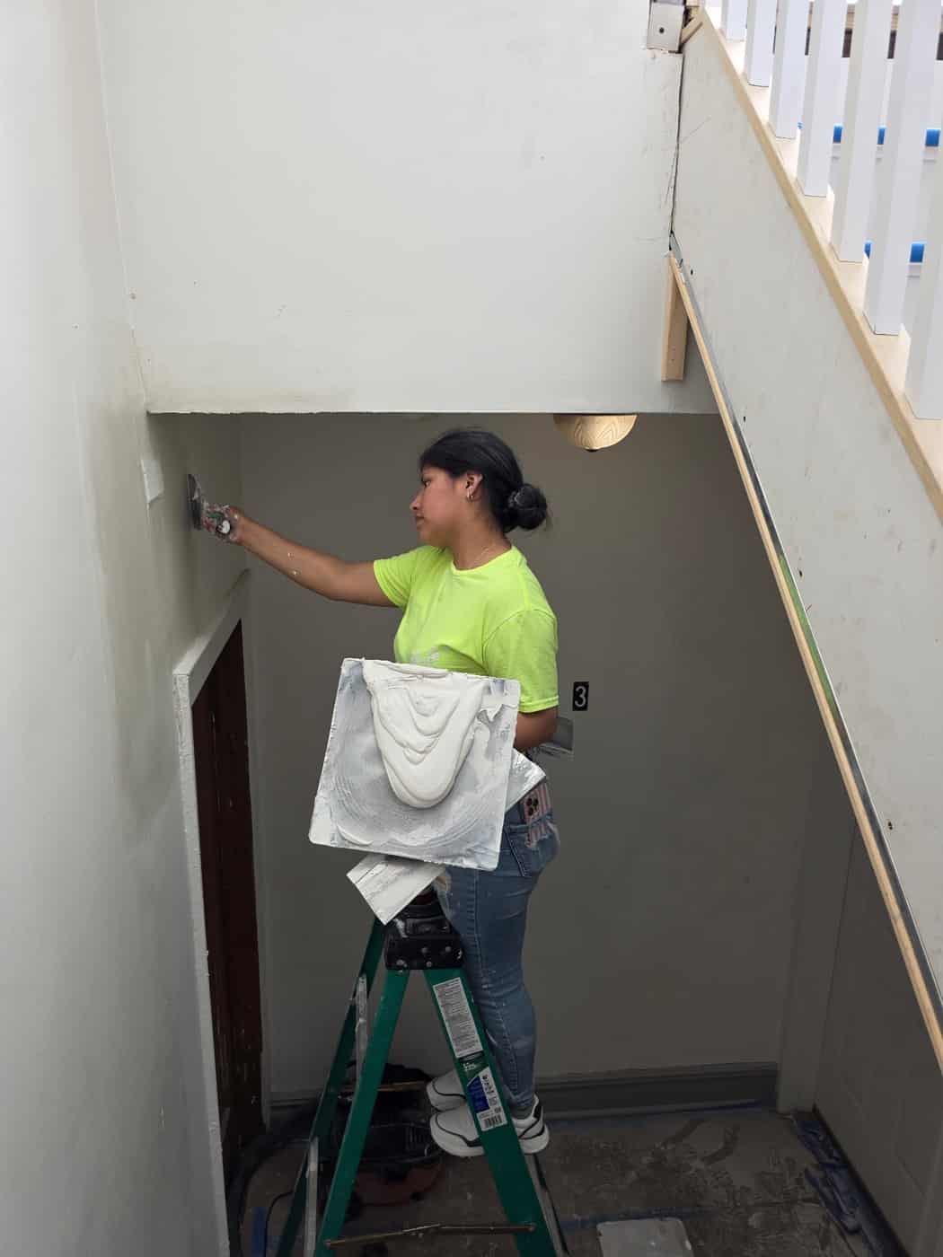 Painter working a clean edge along a doorway