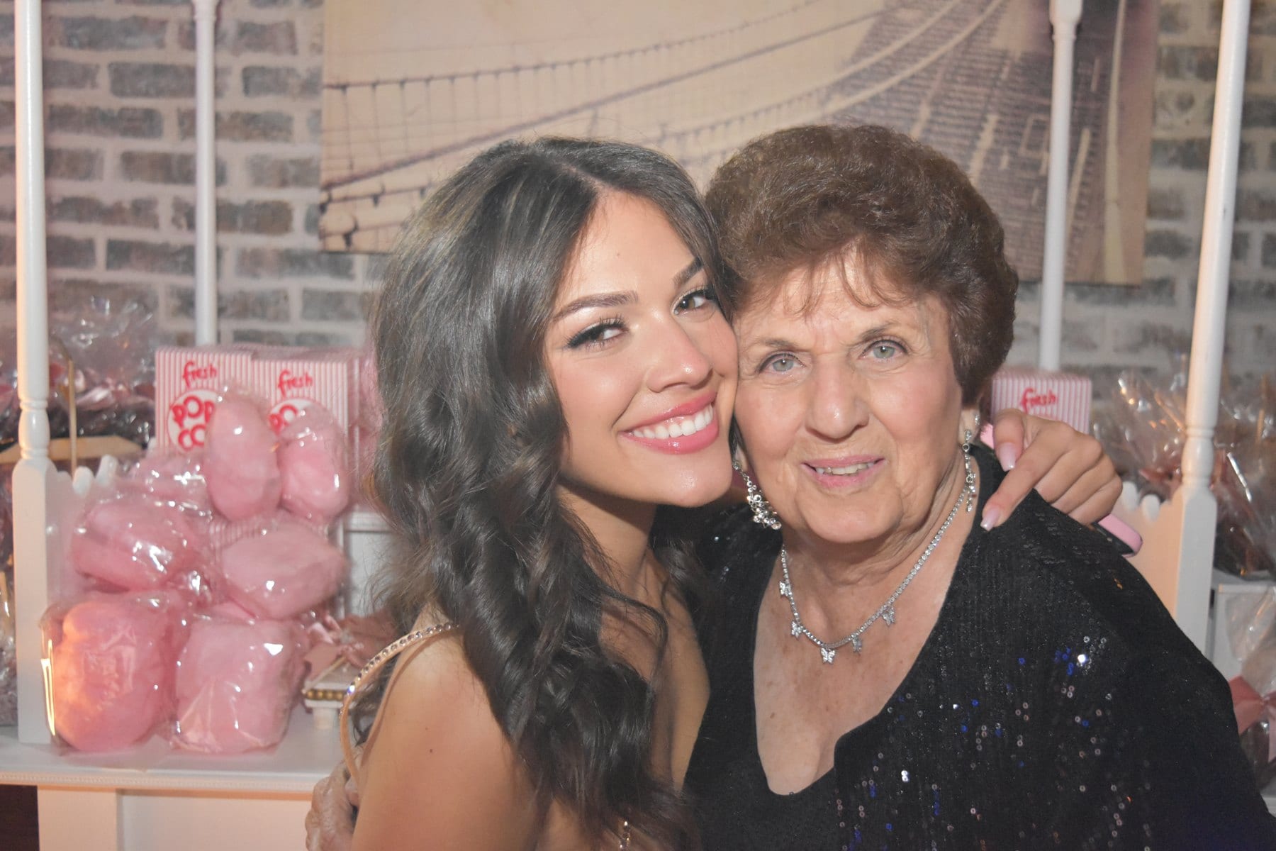Two guests photographed together at a private celebration