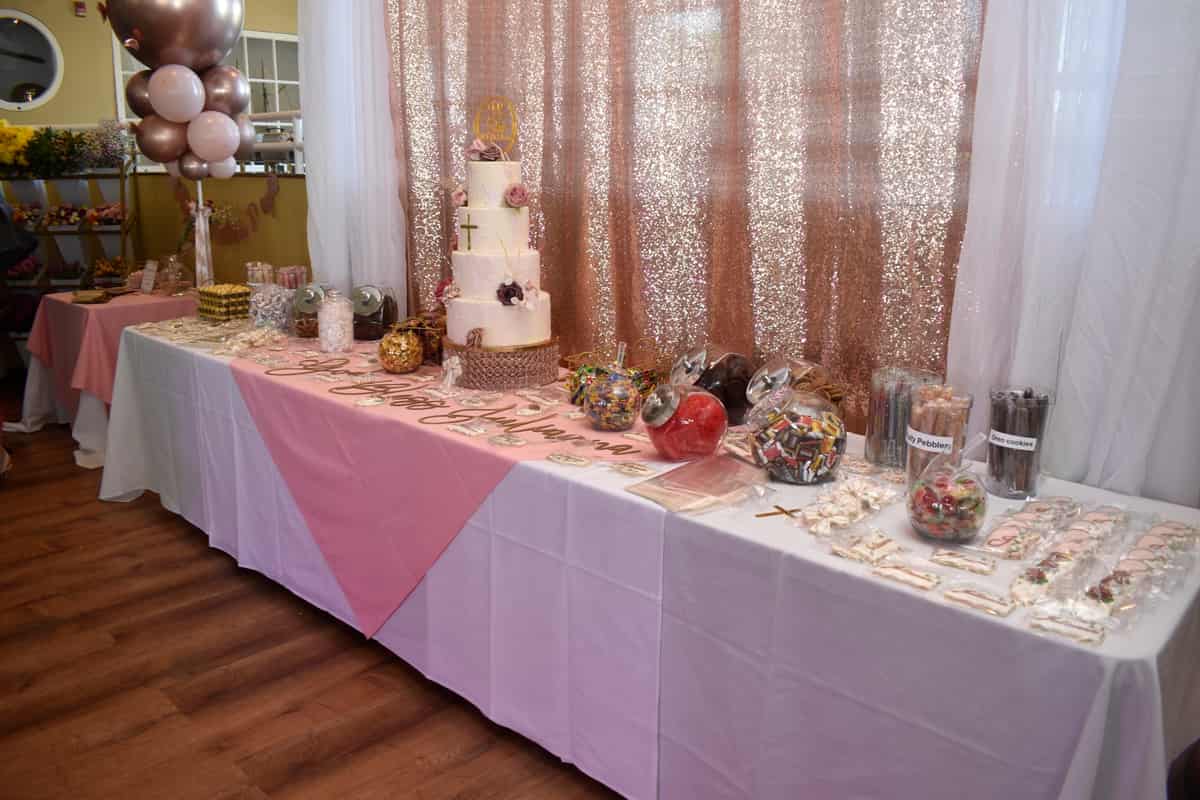 Dessert table styled in pink and gold at a private celebration