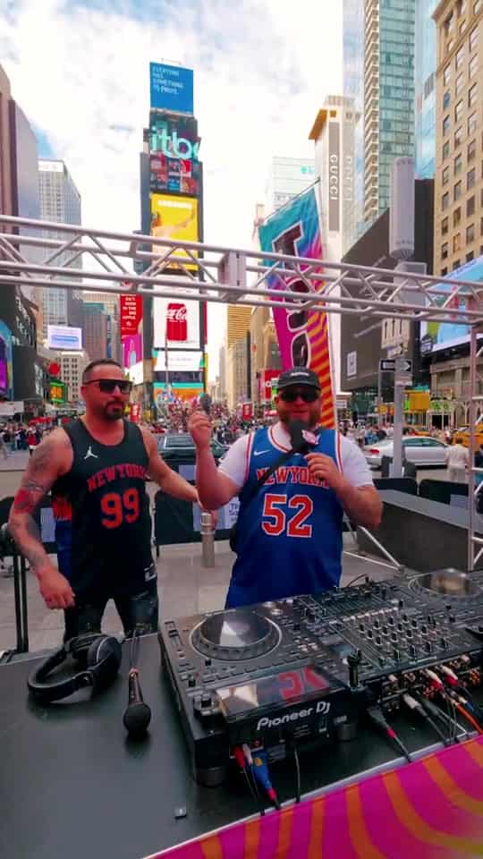 Two performers in Times Square surrounded by billboards